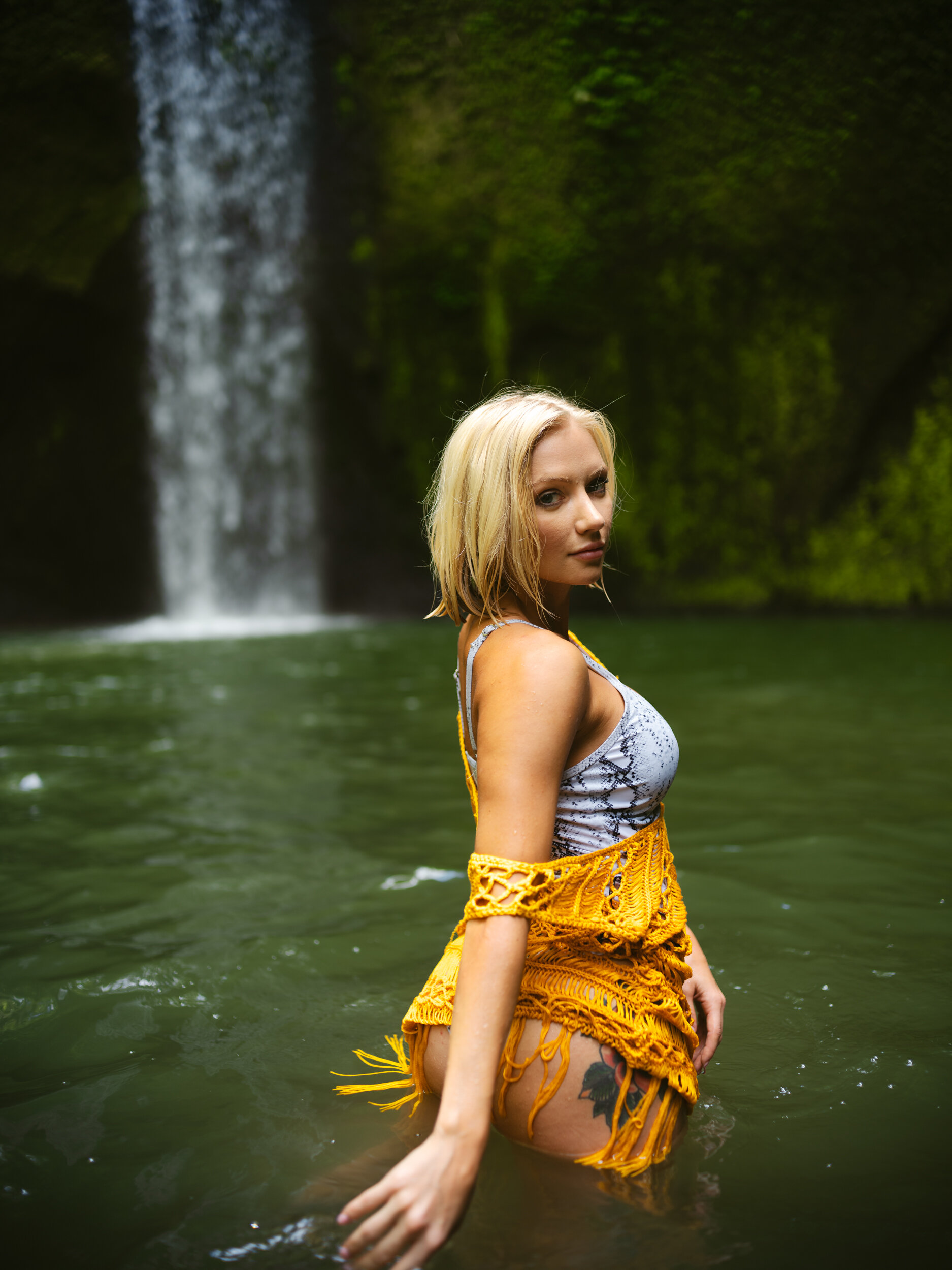 Woman standing in a jungle waterfall pool, Hawaii personal work